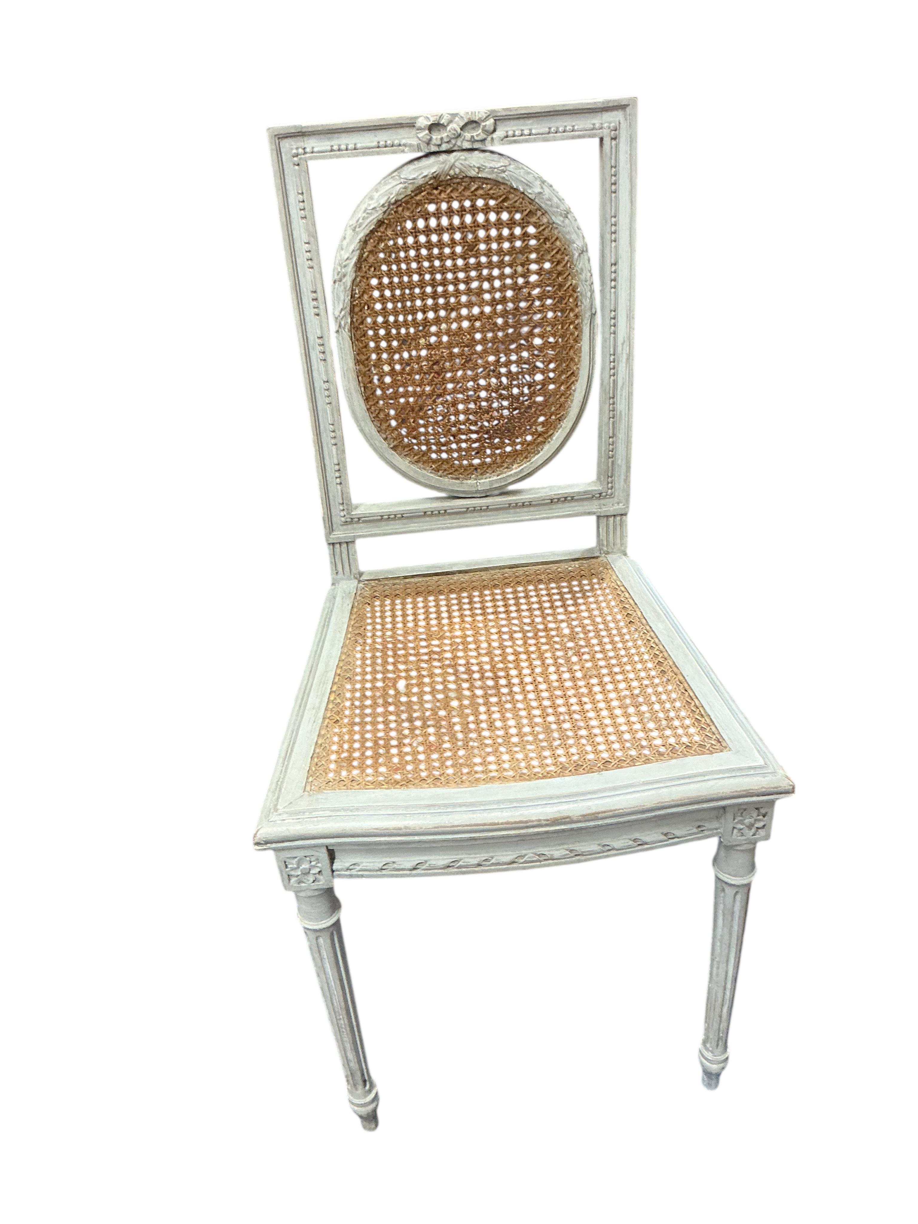 A pair of early 20th century French painted caned side chairs and one other chair